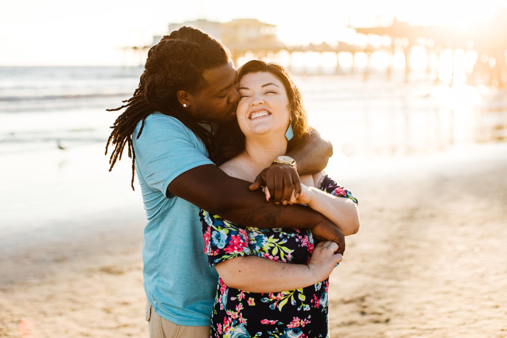 Interracial couple kissing on the beach in Santa Monica