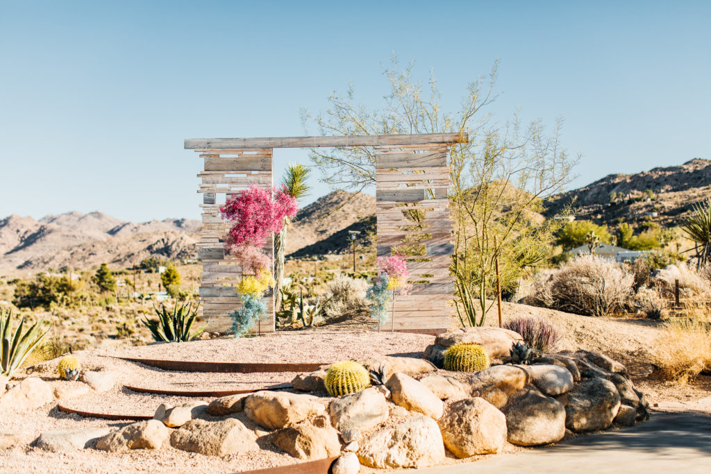 Joshua Tree elopement with colorful details featuring baby's breath altar