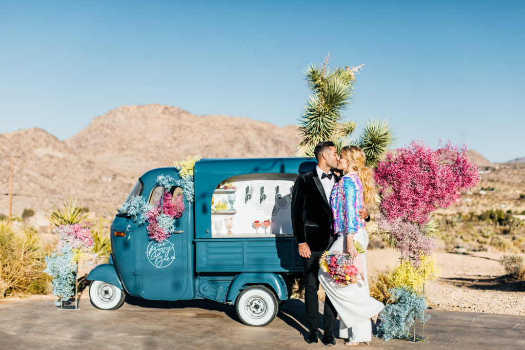Colorful Joshua Tree elopement with couple kissing in front of vintage tap truck