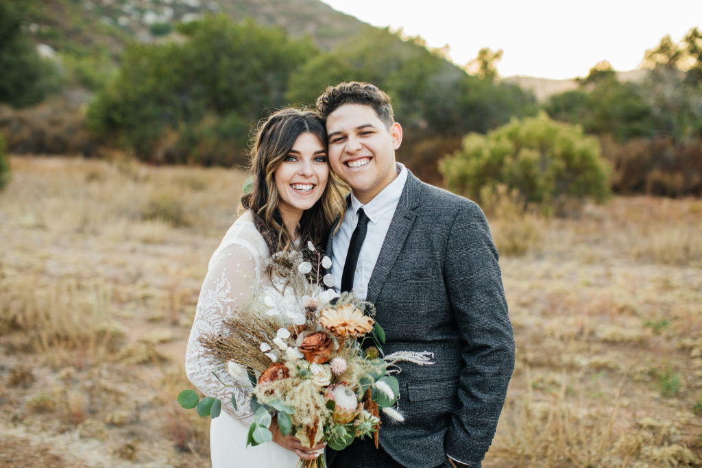 San Diego wedding on a private estate picturing bride and groom smiling at the camera
