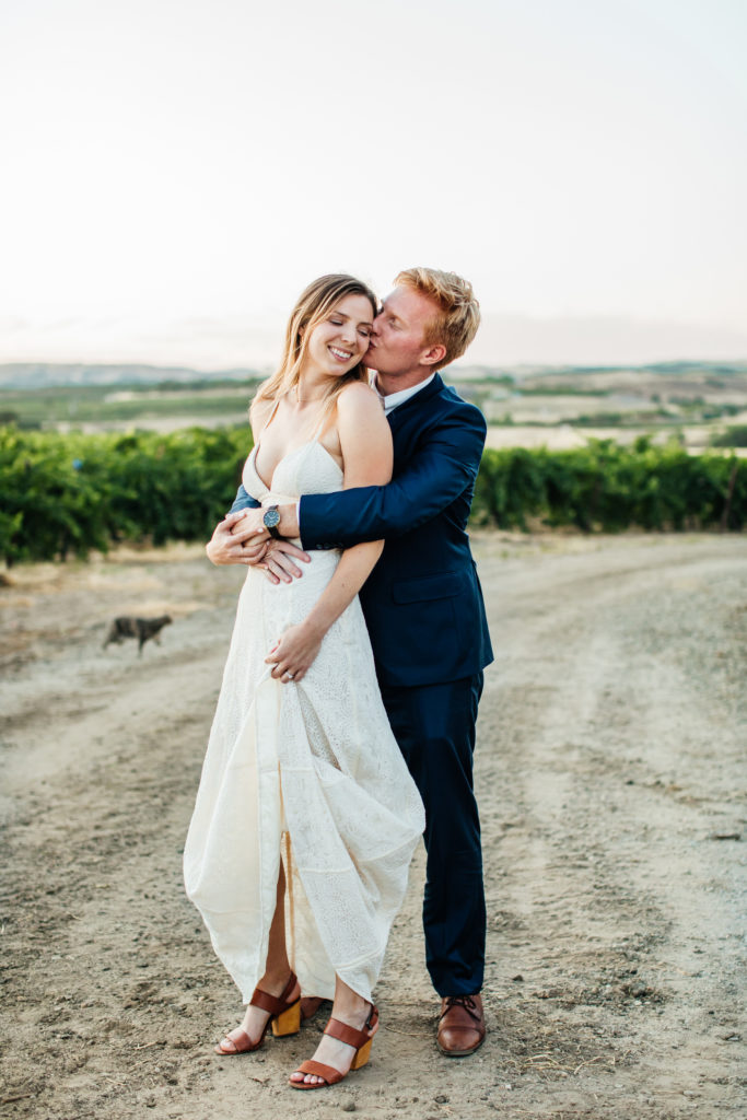bride and groom hold each other and sway during romantic portraits at a tuscan villa 
