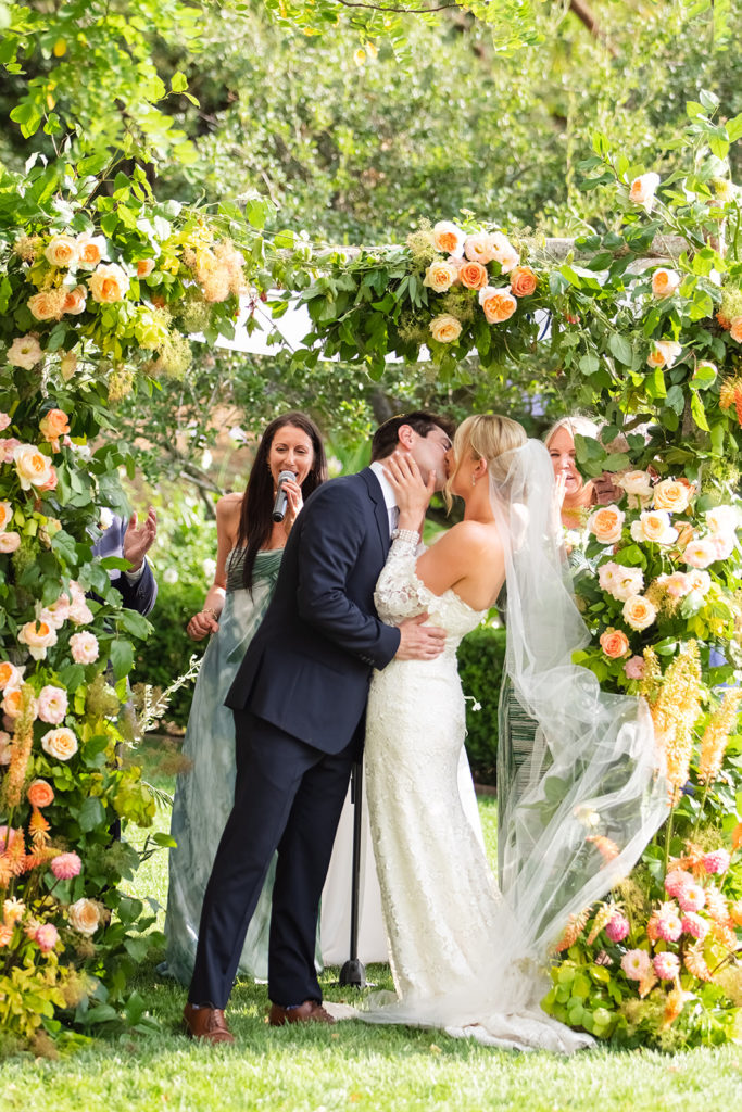 bride and groom kissing under the chuppah