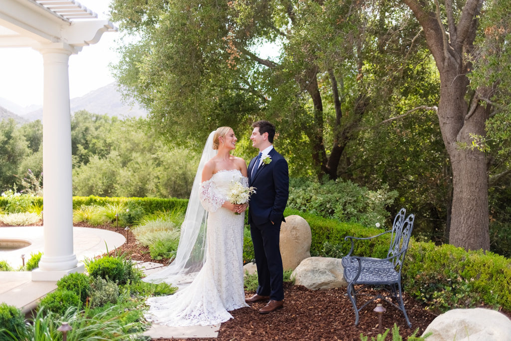 bride and groom laugh together at their garden party wedding in Los Angeles