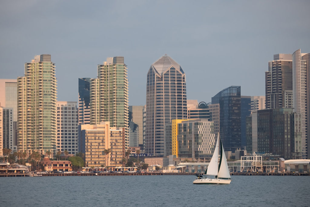 boat sailing in front of San Diego skyline
