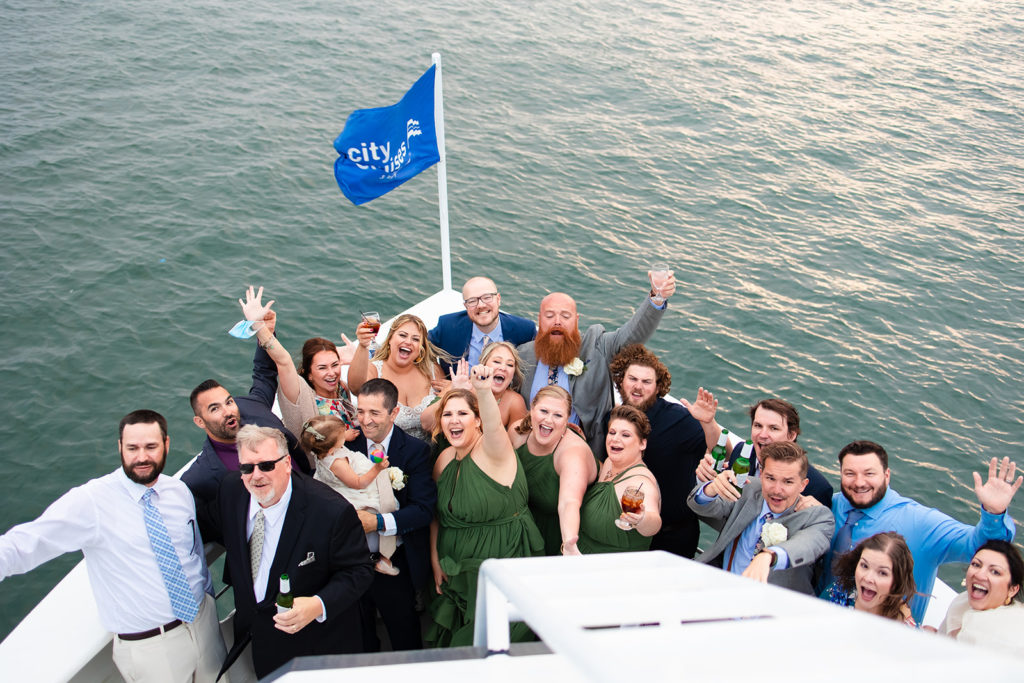 wedding party cheering from boat deck