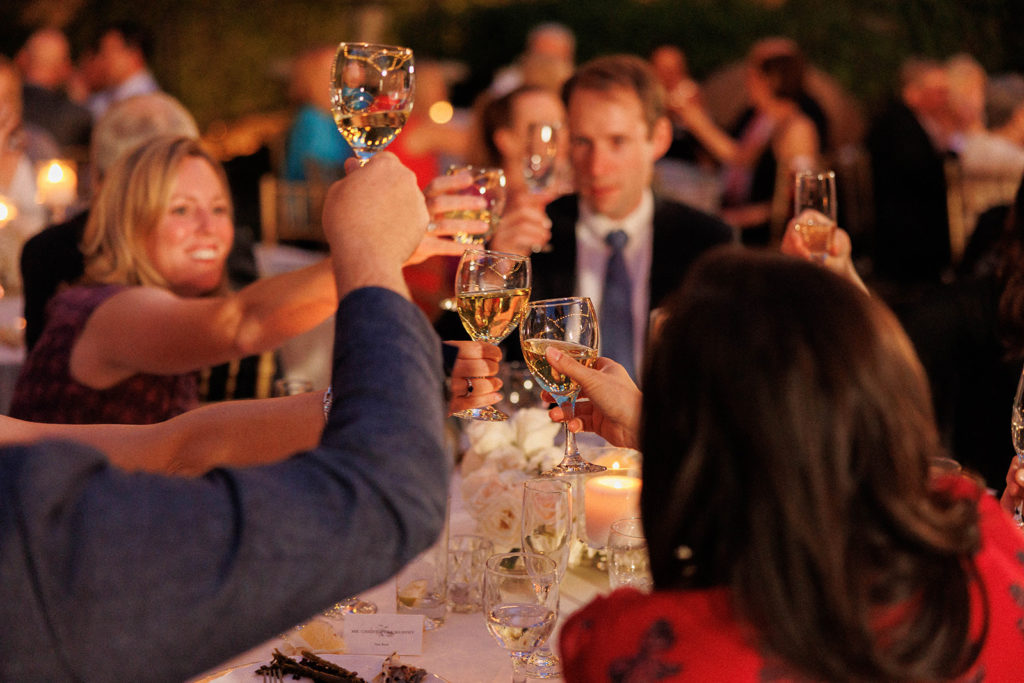 wedding guests cheers with champagne at wedding reception
