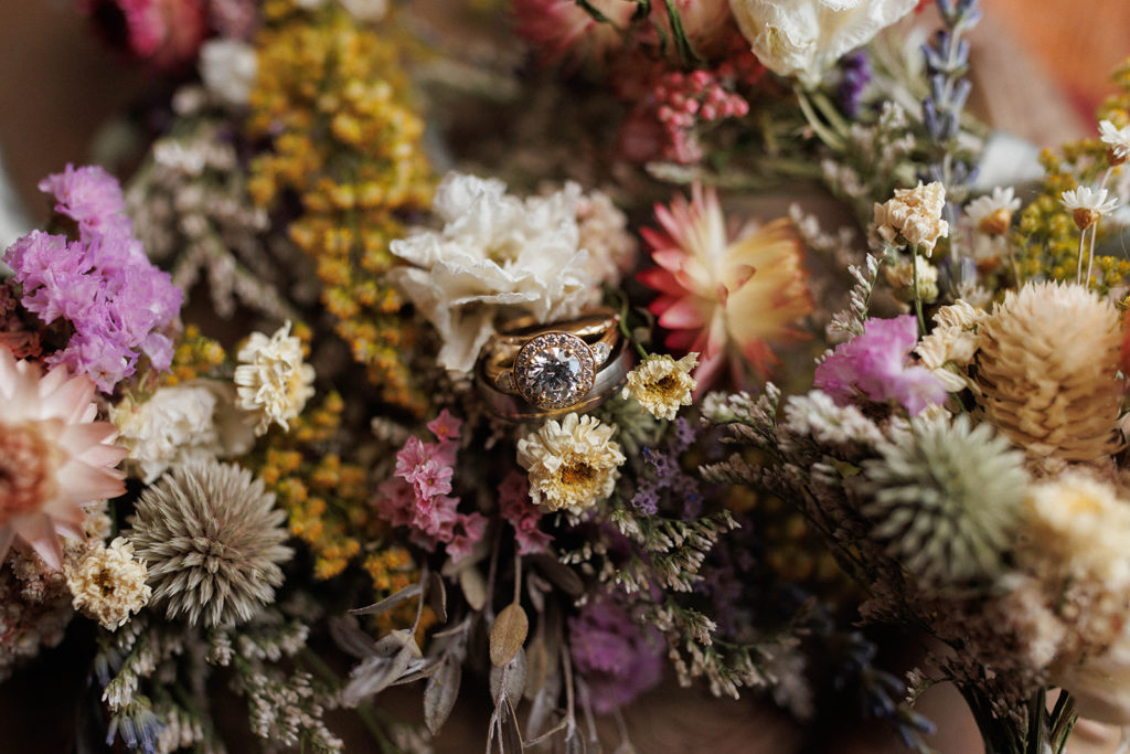 wedding rings in dried floral arrangement