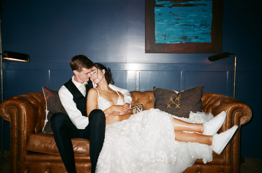 bride and groom on the couch together