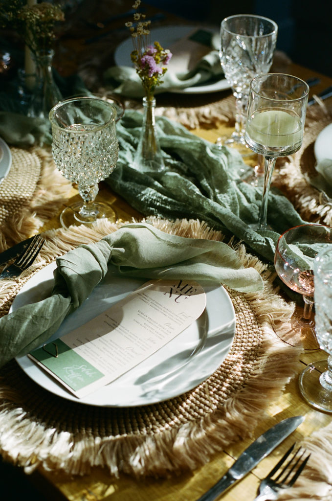film photo of a table setting at a wedding glowing in the sun