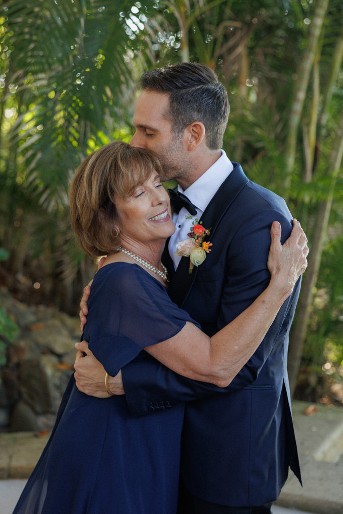 groom and his mom hug during getting ready photos