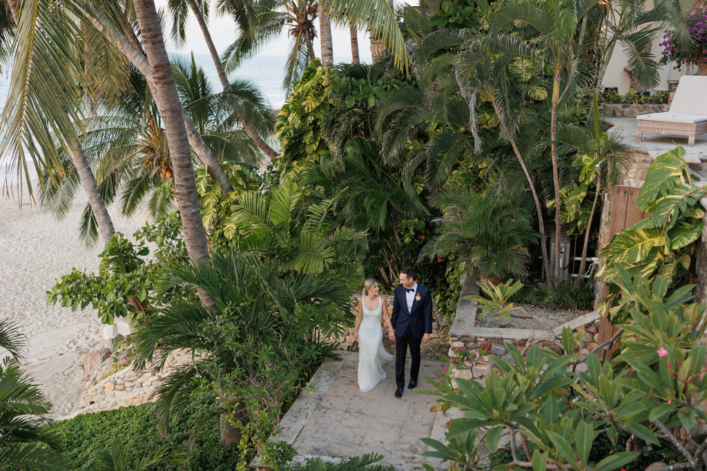 bride and groom kiss on the steps of their mexico wedding venue