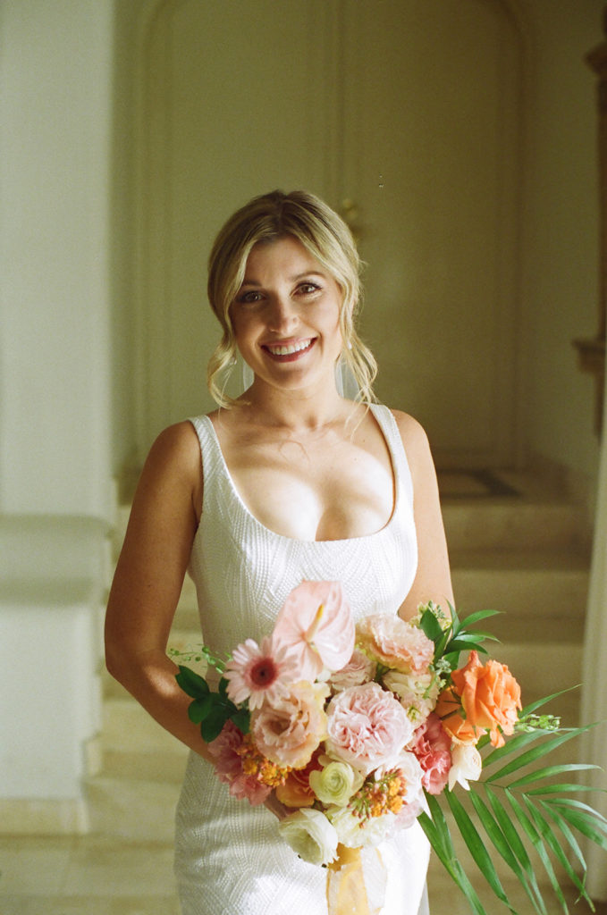 portrait of bride on film with her colorful wedding bouquet