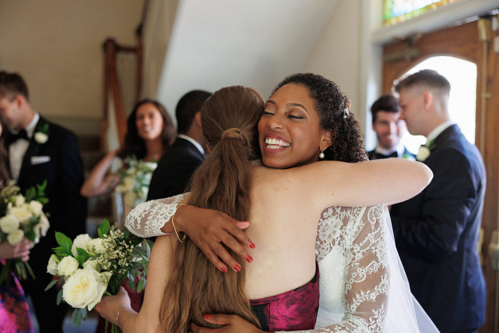 bride hugs her friend after wedding ceremony 