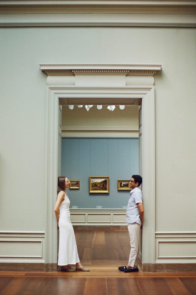 couple stands perfectly framed by the doorway for a unique engagement photo