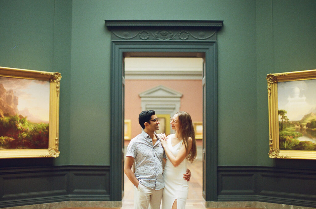 couple stands perfectly framed by museum rotunda