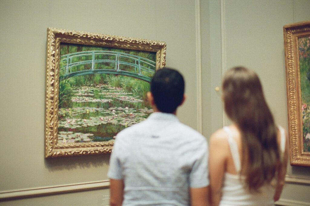 couple admires Monet's water lilies together in a museum