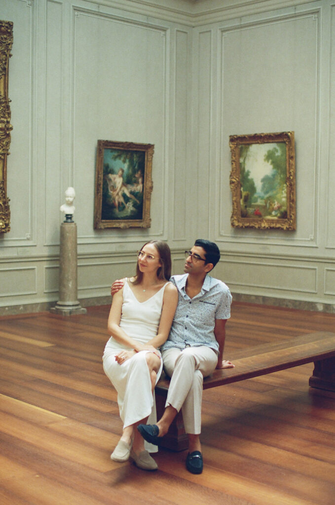 couple enjoys a beautiful painting at an art gallery together