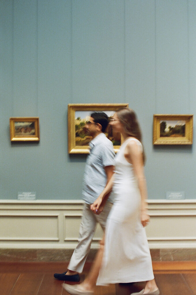 couple strolls museum halls together