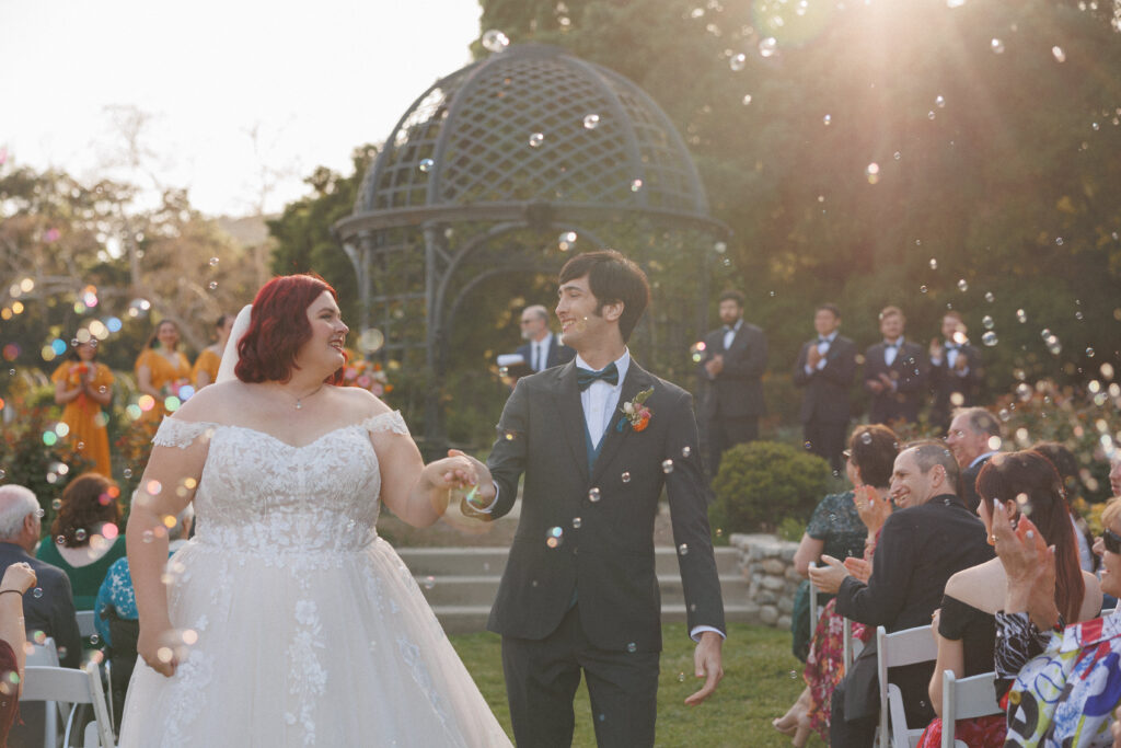 couple exits their wedding surrounded by bubbles