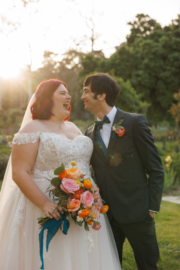 bride and groom laugh together on their wedding day