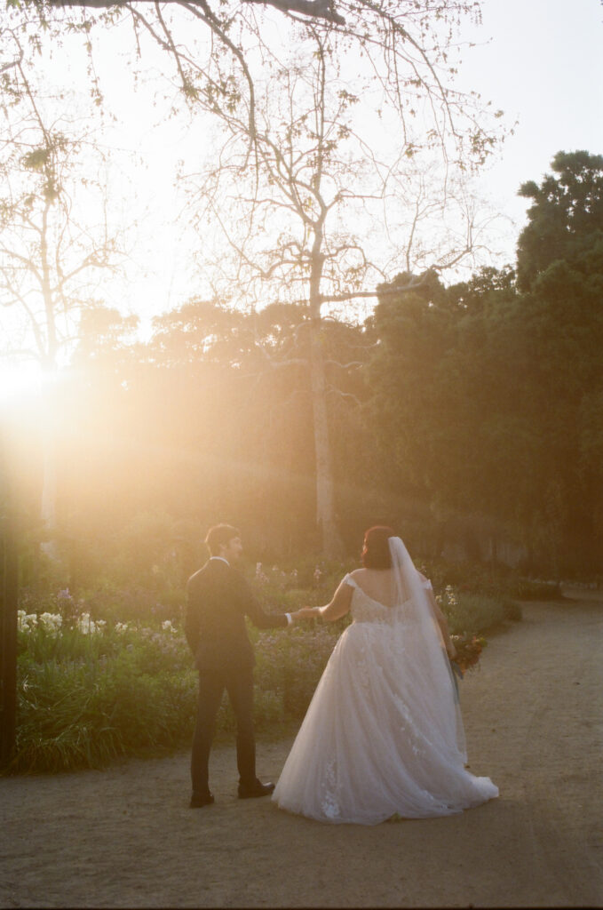 bride and groom walk off into the sunset on their wedding day