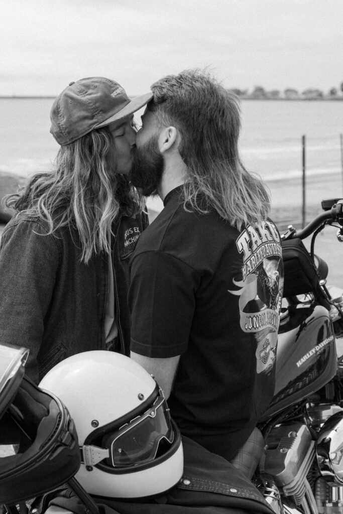 motorcycle couple shares a kiss
