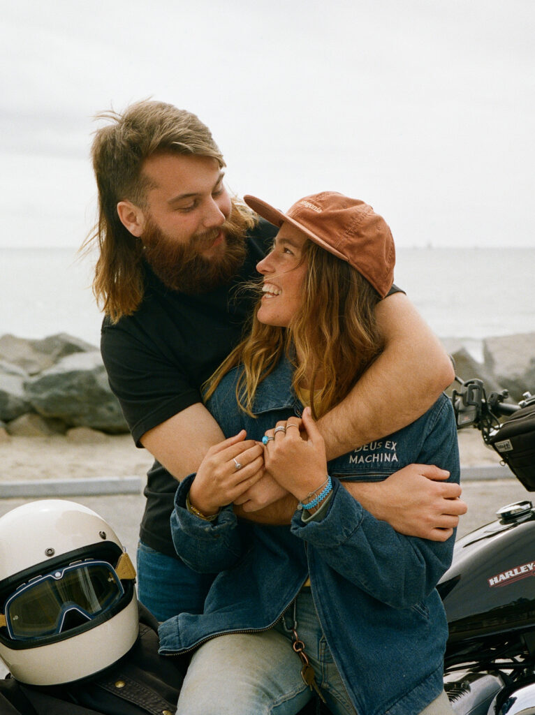 couple embraces on their motorcycle