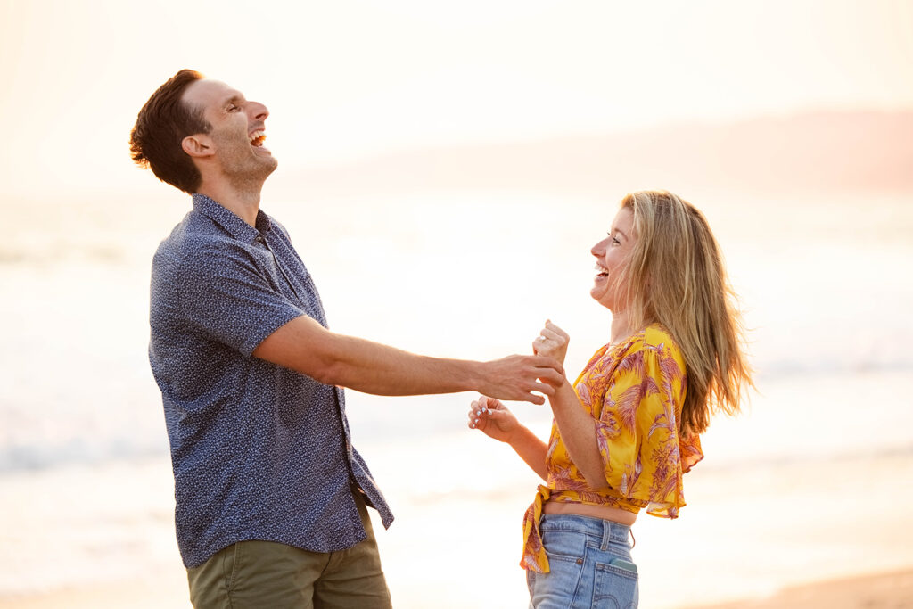 newly engaged couple laughs together in Santa Monica 