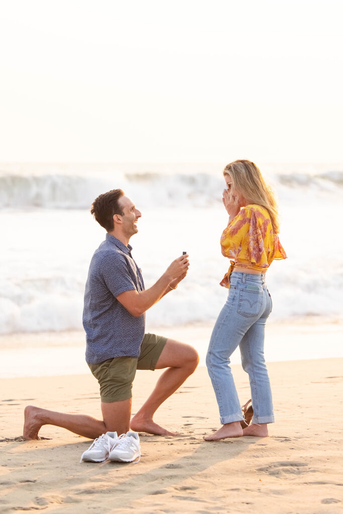 man proposes to his girlfriend in a romantic Santa Monica proposal at sunset