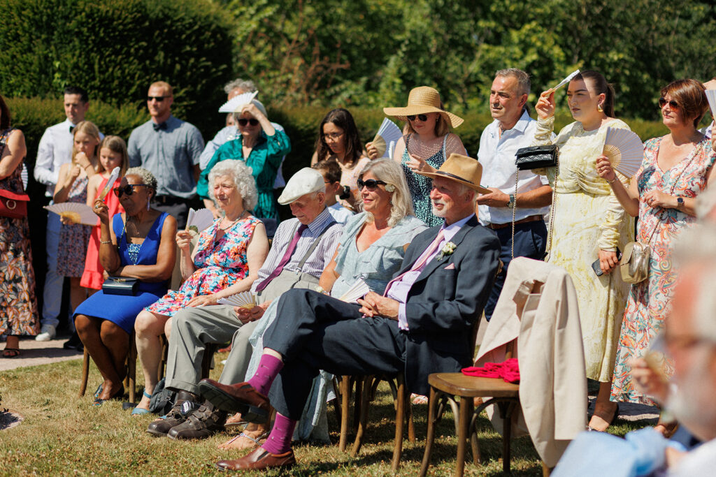 guests gathered for a wedding ceremony in the countryside of france