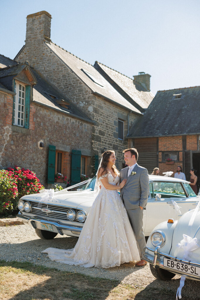 bride and groom celebrate their wedding parade in france surrounded by classic cars