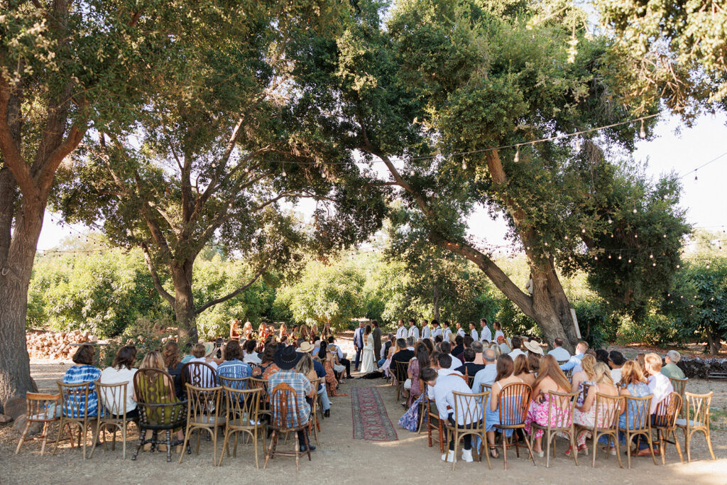 Ceremony outdoors under oak trees