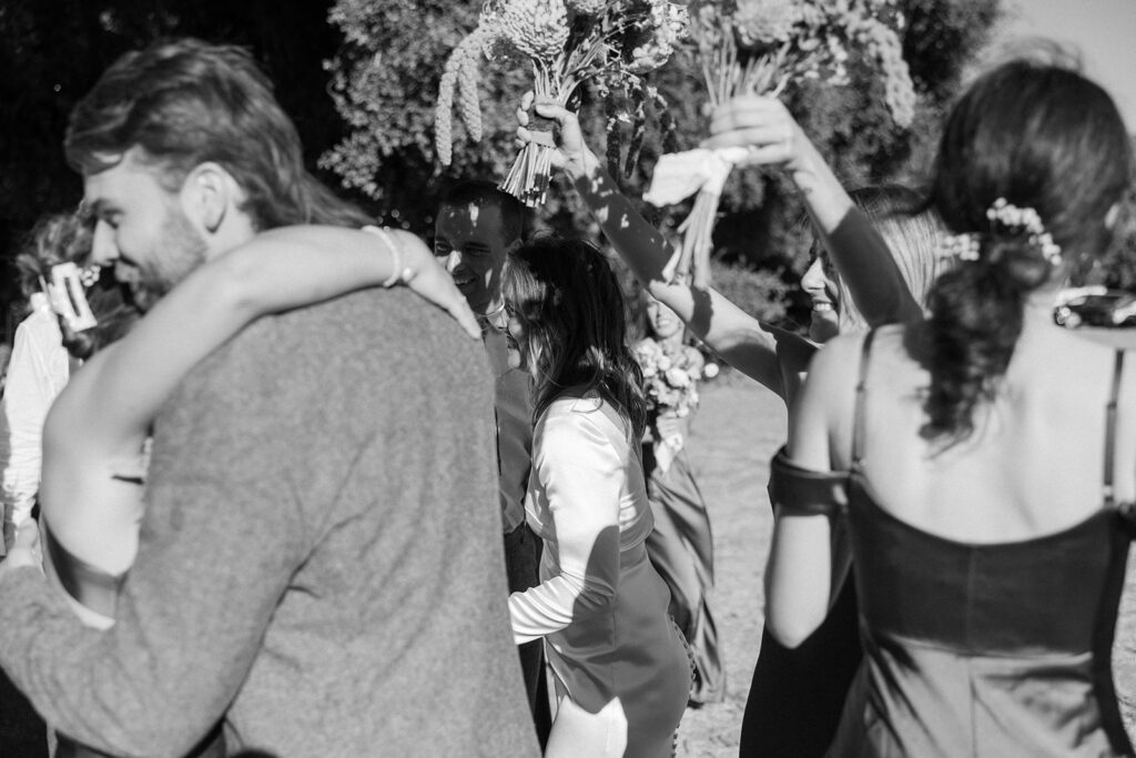 black and white film shot of hugs after ceremony 