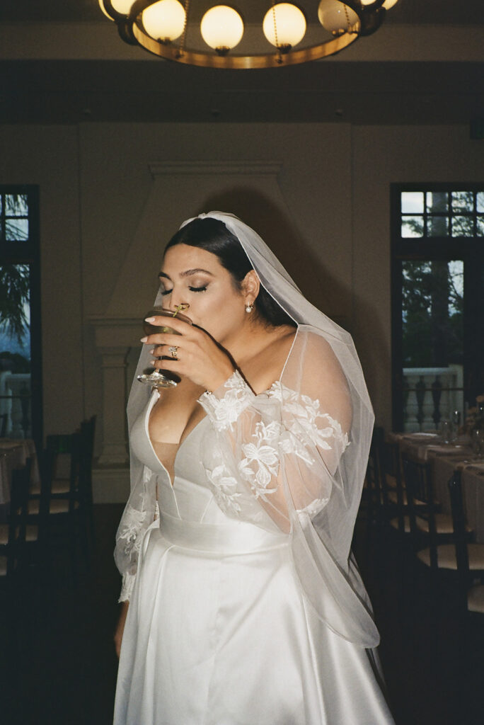 bride taking sip of martini 