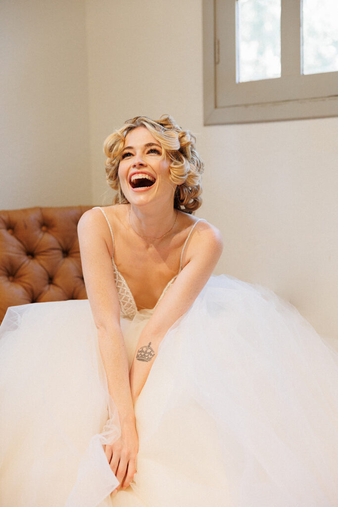 bride has her Marilyn Monroe moment with her hair up in curlers during getting ready