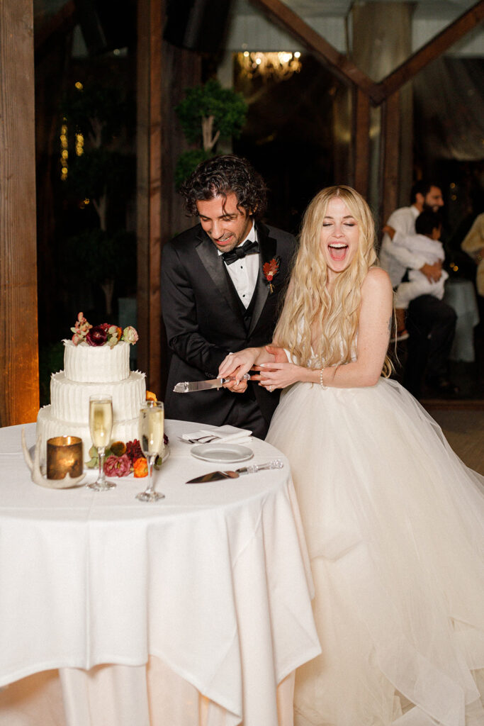 actor Noah James cuts the wedding cake with his wife Norma 