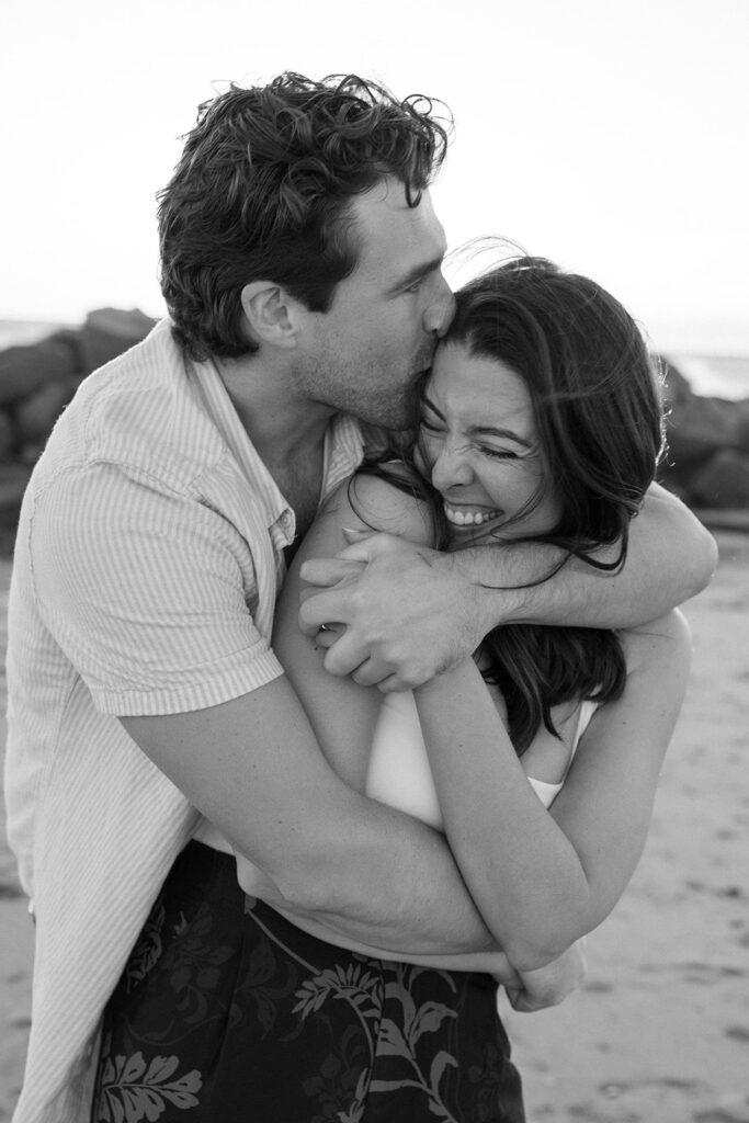 black and white photo of a hug and kiss 