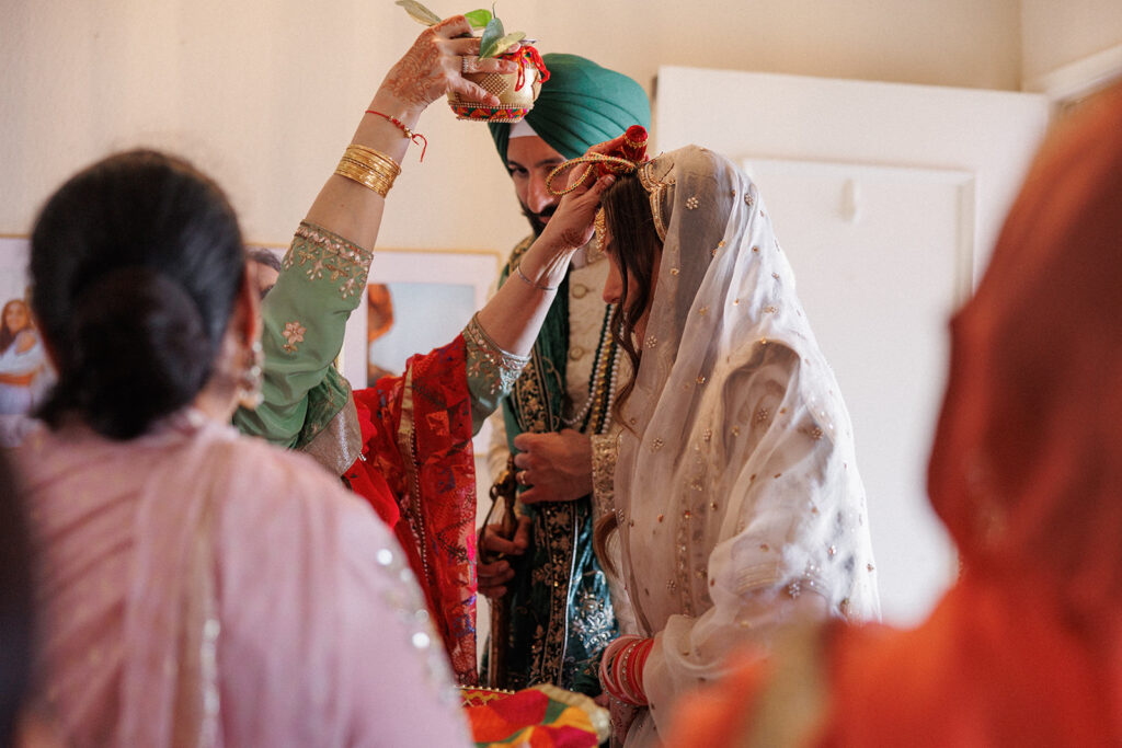 Bride and groom being blessed in their home 