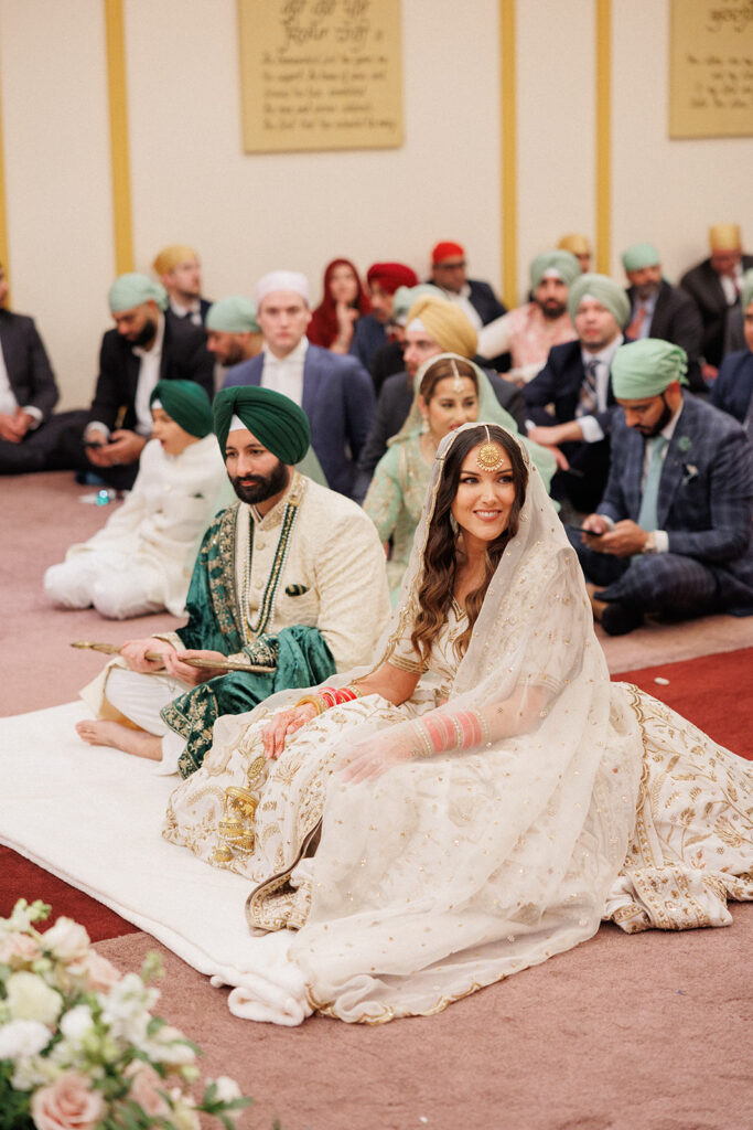 Traditional Sikh ceremony with the bride and groom sitting 