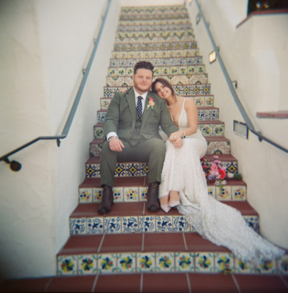 film photo of bride and groom on Spanish staircase 