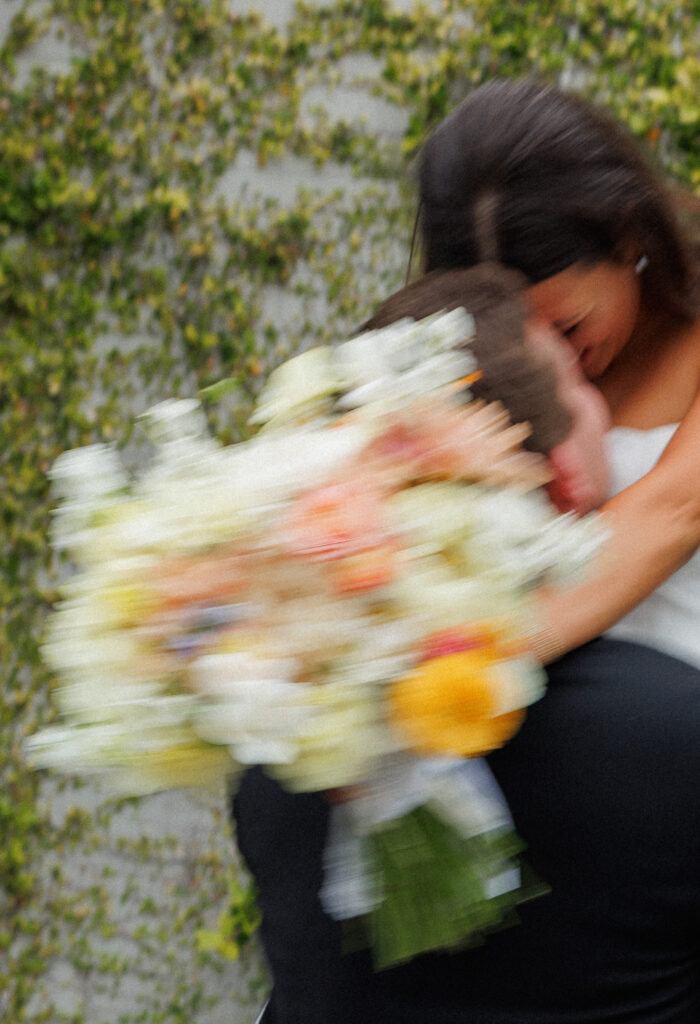 motion photo of bride and groom featuring bouquet 