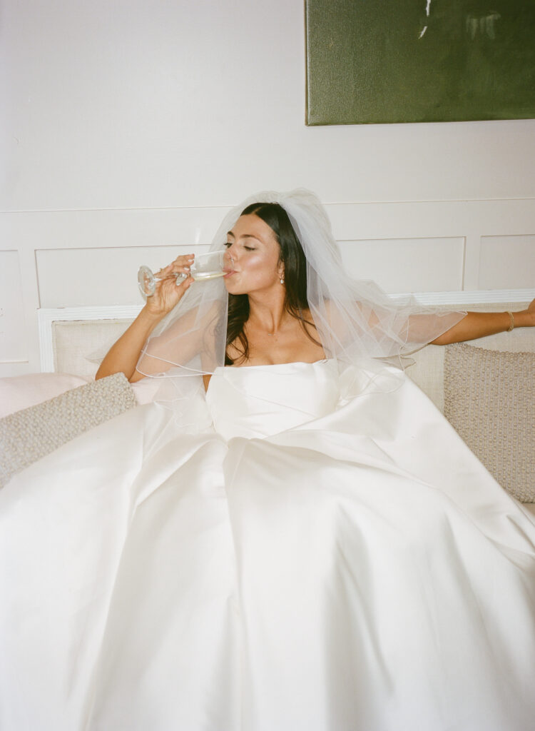 bride enjoying a glass of champagne before the ceremony 