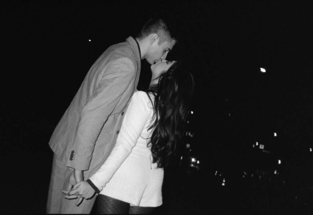 Romantic close-up of the couple framed by capturing an intimate moment in black and white. 