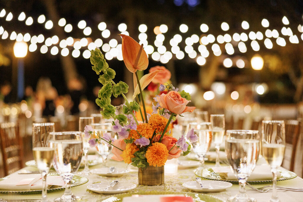 orange, green, and purple centerpiece florals
