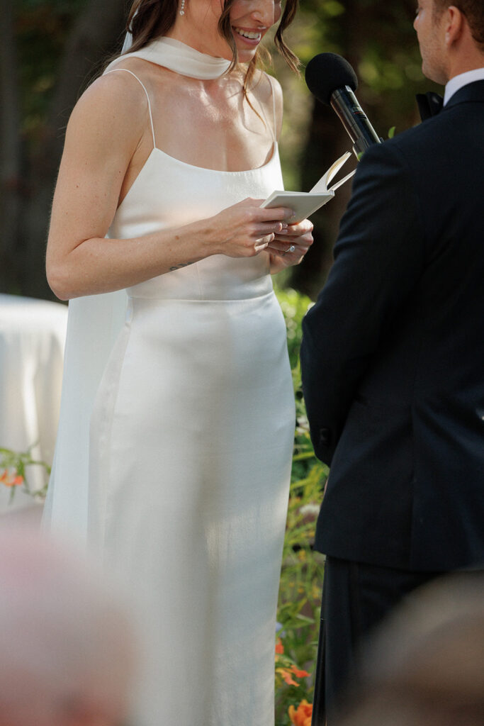 close up view of bride reading her vows to the groom at their Calamigos Ranch wedding ceremony 